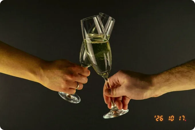 Two hands toasting with champagne flutes